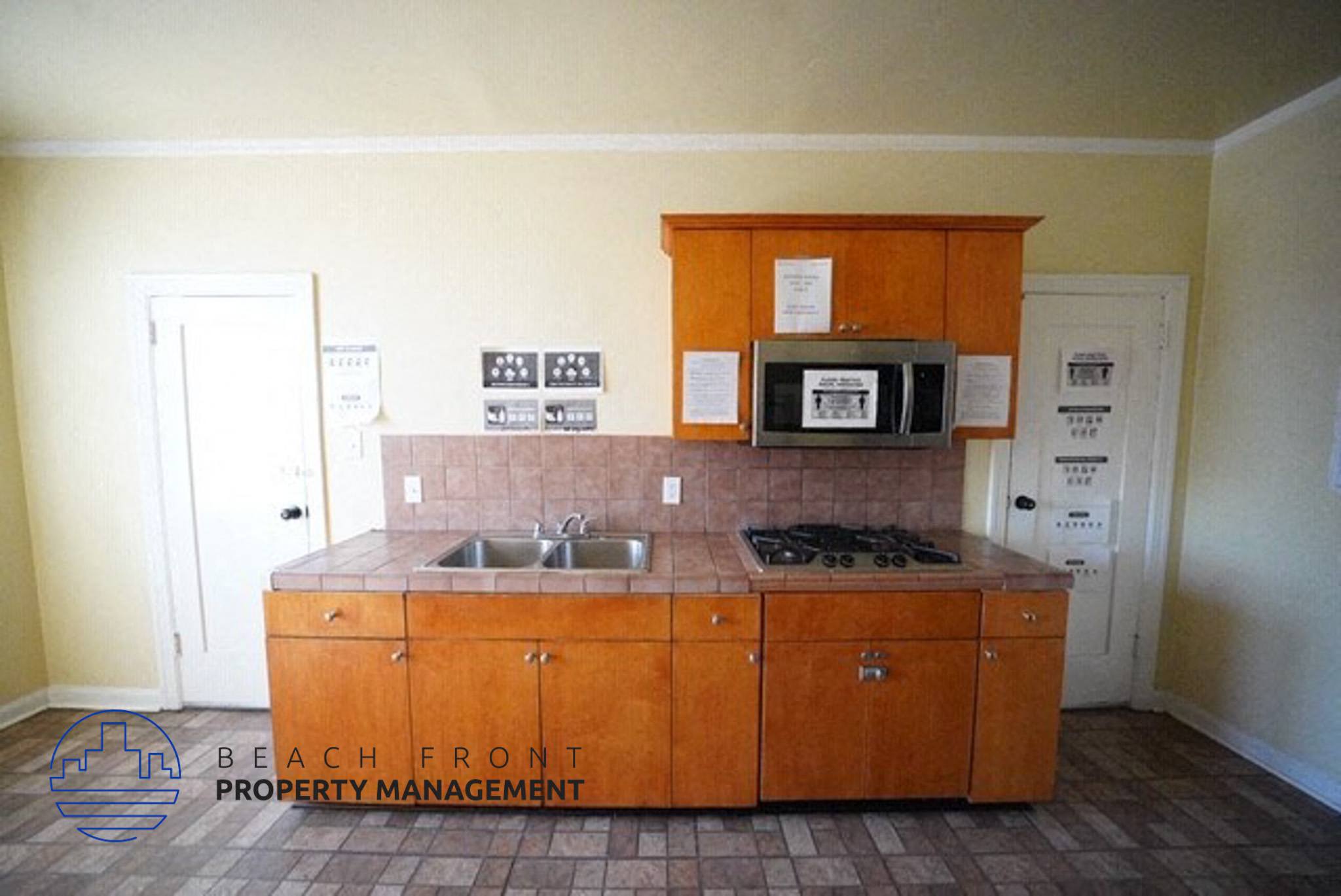 a kitchen with wooden cabinets and a sink and a microwave